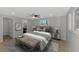 Stylishly furnished main bedroom with ceiling fan, wood floors, and bright windows at 510 S Venice Blvd, Venice, FL 34293