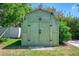 An outbuilding offers extra storage space in the verdant, green yard at 510 S Venice Blvd, Venice, FL 34293