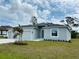 Charming single-story home with a three-car garage, lush lawn, and a decorative palm tree at 5113 Rilke Ln, Port Charlotte, FL 33981