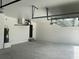 Spacious three-car garage featuring ample storage space and an installed garage door opener at 5113 Rilke Ln, Port Charlotte, FL 33981