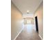 Hallway view leading into a large living room with double french doors and tile flooring at 5113 Rilke Ln, Port Charlotte, FL 33981