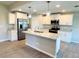 Spacious kitchen features an island, stainless steel appliances, and granite countertops at 5113 Rilke Ln, Port Charlotte, FL 33981