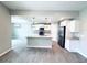 Modern kitchen featuring white cabinets, granite countertops, stainless steel appliances, and a center island at 5113 Rilke Ln, Port Charlotte, FL 33981