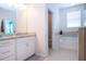Bright bathroom featuring a double sink vanity and a separate soaking tub at 5252 Bentgrass Way, Bradenton, FL 34211