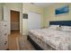 Bedroom featuring two arched windows, light-green walls, and beach-themed decor at 5252 Bentgrass Way, Bradenton, FL 34211