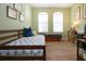 Bedroom with green walls, wood floors, and two beds by the window at 5252 Bentgrass Way, Bradenton, FL 34211