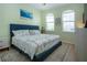 Bedroom features two arched windows, light-green walls, and beach-themed decor at 5252 Bentgrass Way, Bradenton, FL 34211