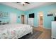 Bedroom with blue walls, ceiling fan, wood floors and a large window at 5252 Bentgrass Way, Bradenton, FL 34211