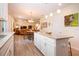 Open concept kitchen with an island, white cabinets, and views into the living and dining spaces at 5252 Bentgrass Way, Bradenton, FL 34211
