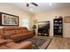 Inviting living room featuring a comfortable leather sofa, stylish rug, and entertainment center with large-screen television at 5252 Bentgrass Way, Bradenton, FL 34211