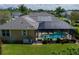 Aerial perspective showcasing the pool, the solar panels on the roof, and the landscaped backyard at 5603 90Th Avenue E Cir, Parrish, FL 34219