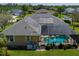 A high angle shows this home has solar panels, screened pool, spacious yard, and well-maintained landscaping at 5603 90Th Avenue E Cir, Parrish, FL 34219