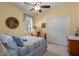 Cozy bedroom with a ceiling fan, natural light from the window, and closet for storage at 5603 90Th Avenue E Cir, Parrish, FL 34219