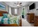 Comfortable bedroom features a large bed, a ceiling fan, and sliding doors to a patio at 5603 90Th Avenue E Cir, Parrish, FL 34219