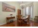 Elegant dining room featuring hardwood floors, a crystal chandelier, and large windows with natural light at 5603 90Th Avenue E Cir, Parrish, FL 34219