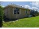 Exterior view showing the home's architecture, landscaping, and screened-in lanai with a partial view of the yard at 5603 90Th Avenue E Cir, Parrish, FL 34219