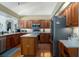 Spacious kitchen featuring hardwood floors, an island, stainless steel appliances, and wood cabinetry at 5603 90Th Avenue E Cir, Parrish, FL 34219