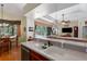 Open concept kitchen features granite countertops and a view into the adjacent living room at 5603 90Th Avenue E Cir, Parrish, FL 34219
