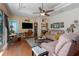 Comfortable living room features tray ceiling, ceiling fan, hardwood floors, and neutral paint at 5603 90Th Avenue E Cir, Parrish, FL 34219