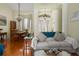 Inviting living room and dining area featuring hardwood floors, elegant lighting, and a view of the front entryway at 5603 90Th Avenue E Cir, Parrish, FL 34219