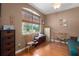 Well-lit home office with a large window, wood floors, and comfortable seating area at 5603 90Th Avenue E Cir, Parrish, FL 34219