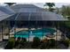 Aerial view of the screened pool featuring an attached spa with a fountain and surrounding deck with seating at 5603 90Th Avenue E Cir, Parrish, FL 34219