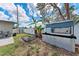 Backyard view featuring a coop, perimeter fencing, mature trees, and a small storage shed at 5732 Beneva Rd, Sarasota, FL 34233