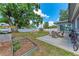 Spacious backyard with a patio, outdoor seating, garden plot, and beautiful landscaping at 5732 Beneva Rd, Sarasota, FL 34233