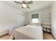 A cozy bedroom features a bed, built in shelves, a ceiling fan, and neutral walls at 5732 Beneva Rd, Sarasota, FL 34233