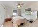 A well-lit bedroom with neutral walls, two windows, a large bed and a full length mirror at 5732 Beneva Rd, Sarasota, FL 34233