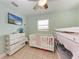 A room with a bunk bed, a crib, dresser, and television for a fun, functional space at 5732 Beneva Rd, Sarasota, FL 34233