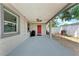 Covered carport area leading to a backyard with a grill, great for outdoor entertaining at 5732 Beneva Rd, Sarasota, FL 34233