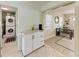 A dining area leads to a laundry room with a stacked washer/dryer, and a table and bench set at 5732 Beneva Rd, Sarasota, FL 34233