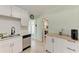 Features include white cabinets, a subway tile backsplash, stainless steel appliances, and a breakfast bar in this kitchen at 5732 Beneva Rd, Sarasota, FL 34233