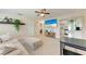 Cozy living room with neutral tones, ceiling fan, and open access to the kitchen at 5732 Beneva Rd, Sarasota, FL 34233