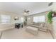Bright living room with neutral colors, ceiling fan, and ample seating for comfortable living at 5732 Beneva Rd, Sarasota, FL 34233