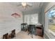 Comfortable office features tile floors, wood accent wall, and lots of natural light at 5732 Beneva Rd, Sarasota, FL 34233
