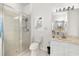 Bathroom showcasing a glass-enclosed shower with a rainfall showerhead, a toilet, and a single sink vanity at 5915 43Rd E Ct, Bradenton, FL 34203