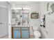 Well-lit bathroom with a blue cabinet, decorated with a charming sea-themed aesthetic at 5915 43Rd E Ct, Bradenton, FL 34203