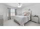 Bright bedroom featuring a mirrored bed frame, large window, and a ceiling fan at 5915 43Rd E Ct, Bradenton, FL 34203