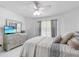 Bright bedroom featuring a dresser with a TV, a large window, and a ceiling fan at 5915 43Rd E Ct, Bradenton, FL 34203