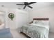 Relaxing bedroom featuring a ceiling fan, closet doors, and a window with blinds at 5915 43Rd E Ct, Bradenton, FL 34203