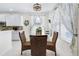 Inviting dining area with modern table, wicker chairs, and adjacent kitchen features at 5915 43Rd E Ct, Bradenton, FL 34203