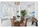 Cozy dining area featuring a glass table with wicker chairs and serene views at 5915 43Rd E Ct, Bradenton, FL 34203