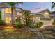 Attractive two-story home with lush landscaping, an arched doorway, and a two-car garage at 5915 43Rd E Ct, Bradenton, FL 34203