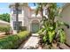Landscaped front entrance with garden beds, shrubs, and a walkway leading to the front door at 5915 43Rd E Ct, Bradenton, FL 34203