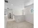 Bright hallway featuring carpet floors, white trim, a black mirror and a round window at 5915 43Rd E Ct, Bradenton, FL 34203