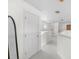 Hallway featuring carpet flooring, an arched window, and a modern full-length mirror at 5915 43Rd E Ct, Bradenton, FL 34203