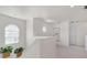 Bright hallway featuring carpet floors, arched windows, white trim, and plants at 5915 43Rd E Ct, Bradenton, FL 34203