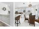 Modern kitchen with white cabinets, stainless appliances, and cozy breakfast bar with wicker stools at 5915 43Rd E Ct, Bradenton, FL 34203